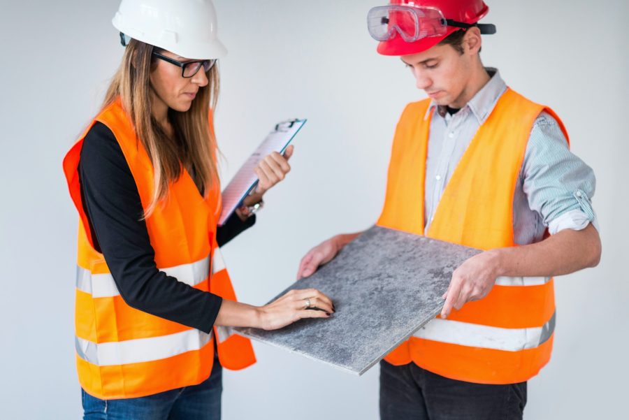 Architects examining tiles on construction site